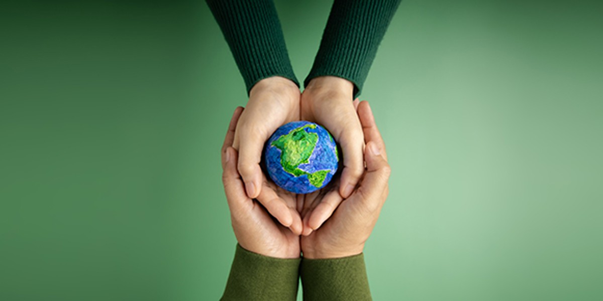 two hands holding a globe